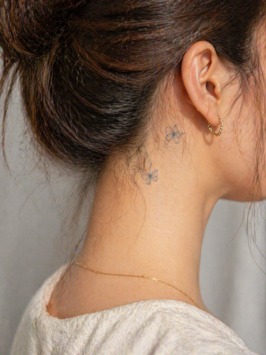Duo butterfly temporary tattoo on neck — Alter Ego Ink fine line lasts 2 weeks