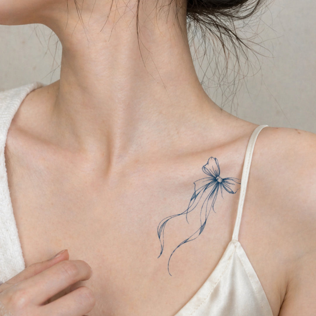 Ribbon bow fine line temporary tattoo on collarbone — Alter Ego Ink botanical waterproof