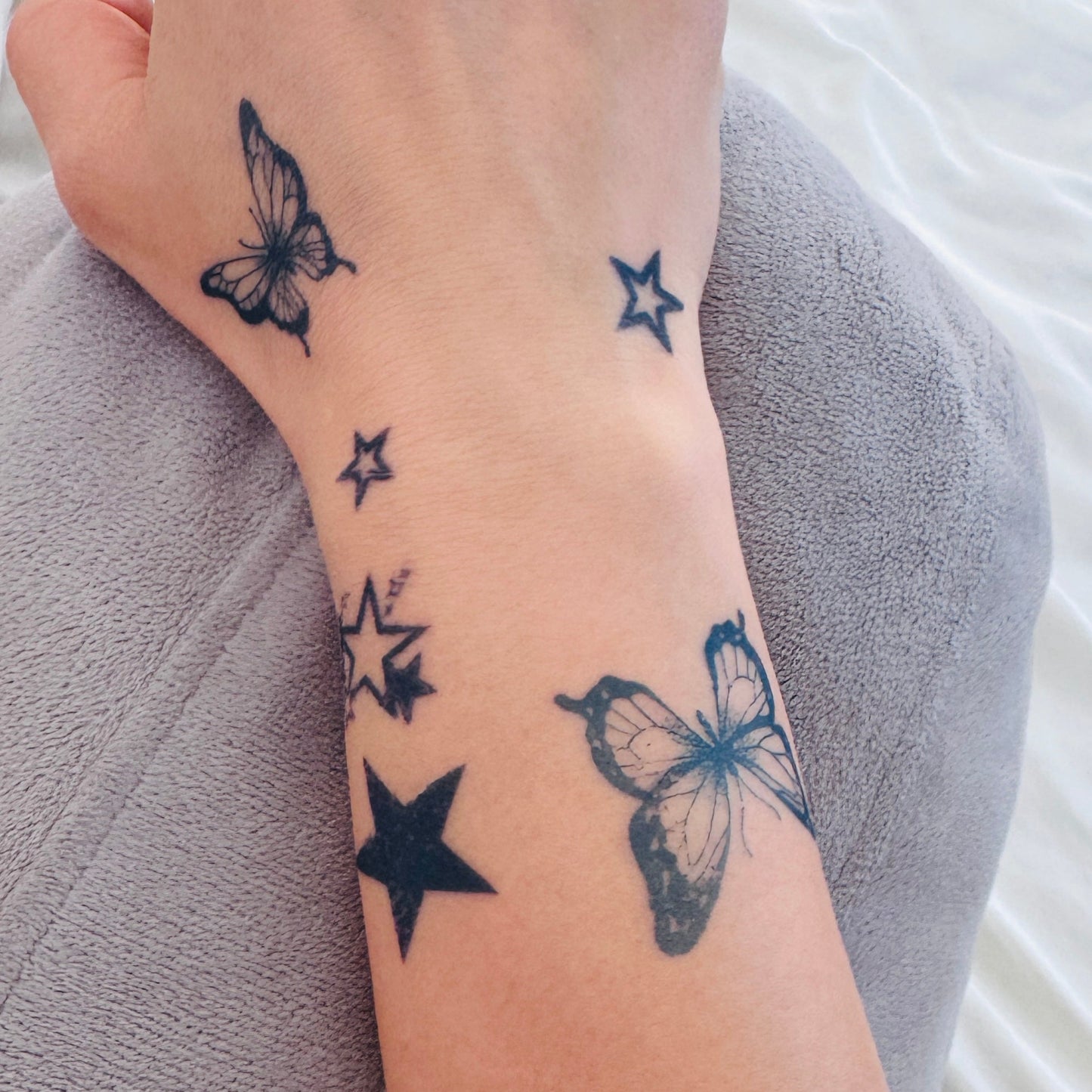 Fine line butterfly temporary tattoo on wrist — Alter Ego Ink lasts 2 weeks