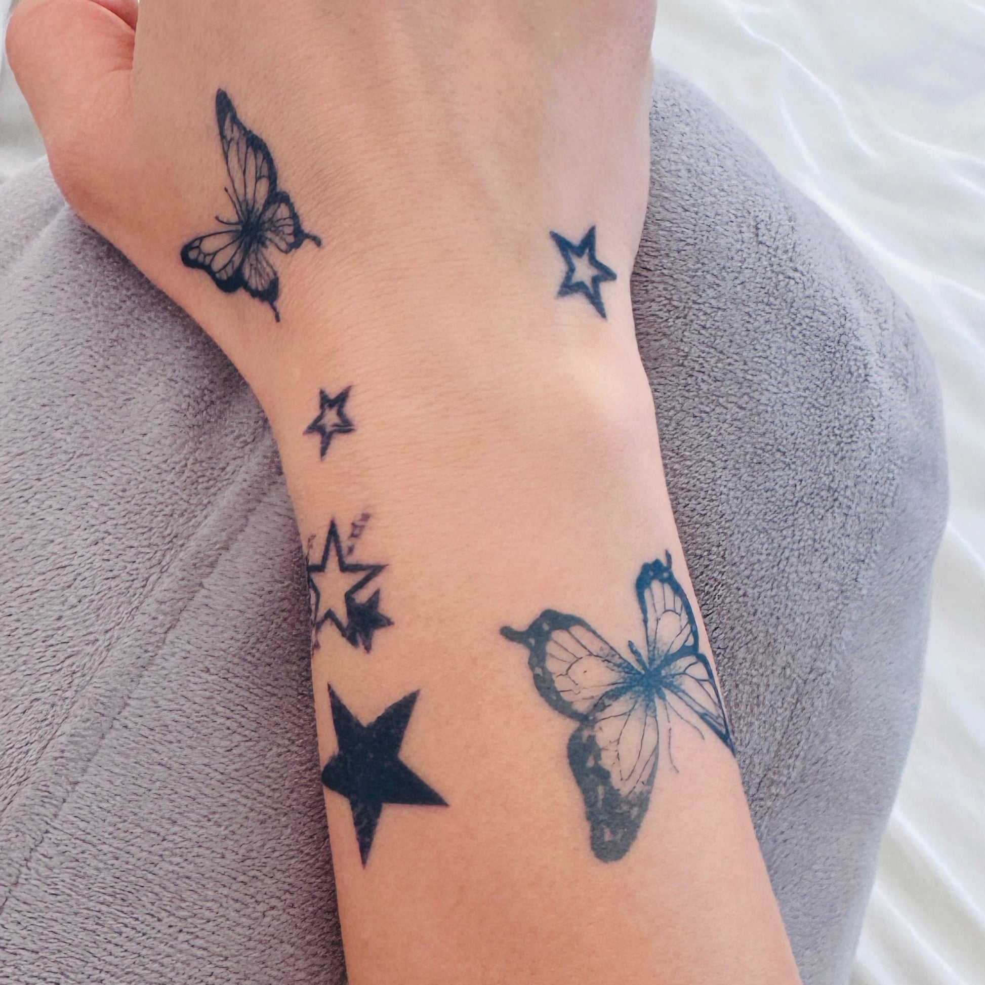 Fine line butterfly temporary tattoo on wrist — Alter Ego Ink lasts 2 weeks