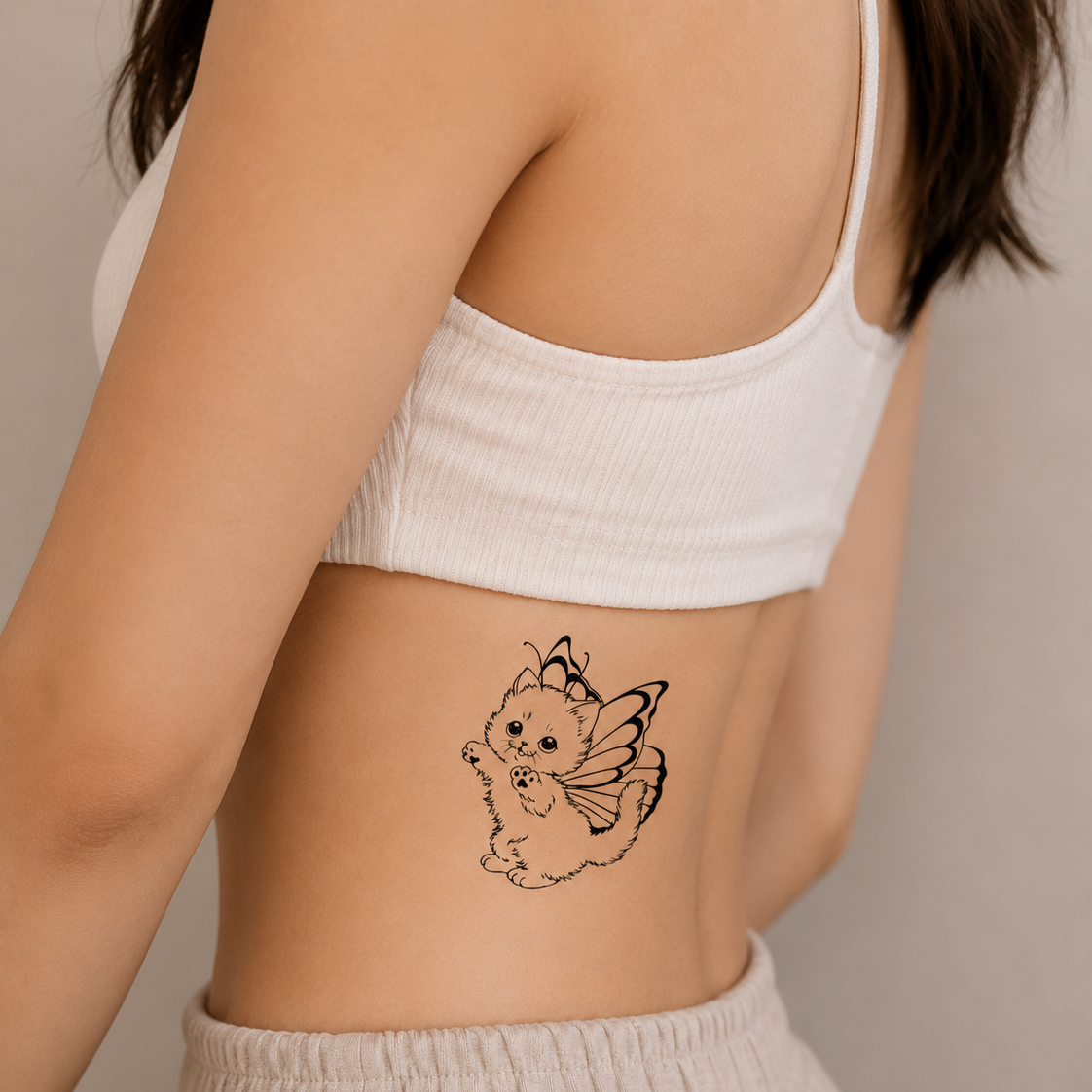 Woman wearing a Butterfly Kitty temporary tattoo on the side rib, cute fairy cat with butterfly wings waterproof temporary tattoo.