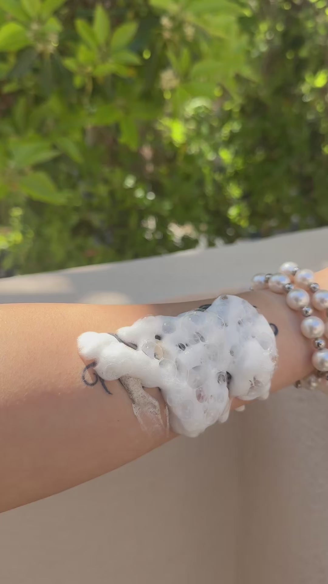 Temporary tattoo waterproof durability test on wrist with soap foam — Alter Ego Ink script tattoo design