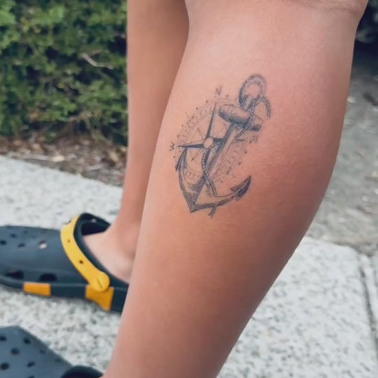 Close-up video of the True North Anchor water-free temporary tattoo on the lower leg, showing the realistic compass and anchor details on skin