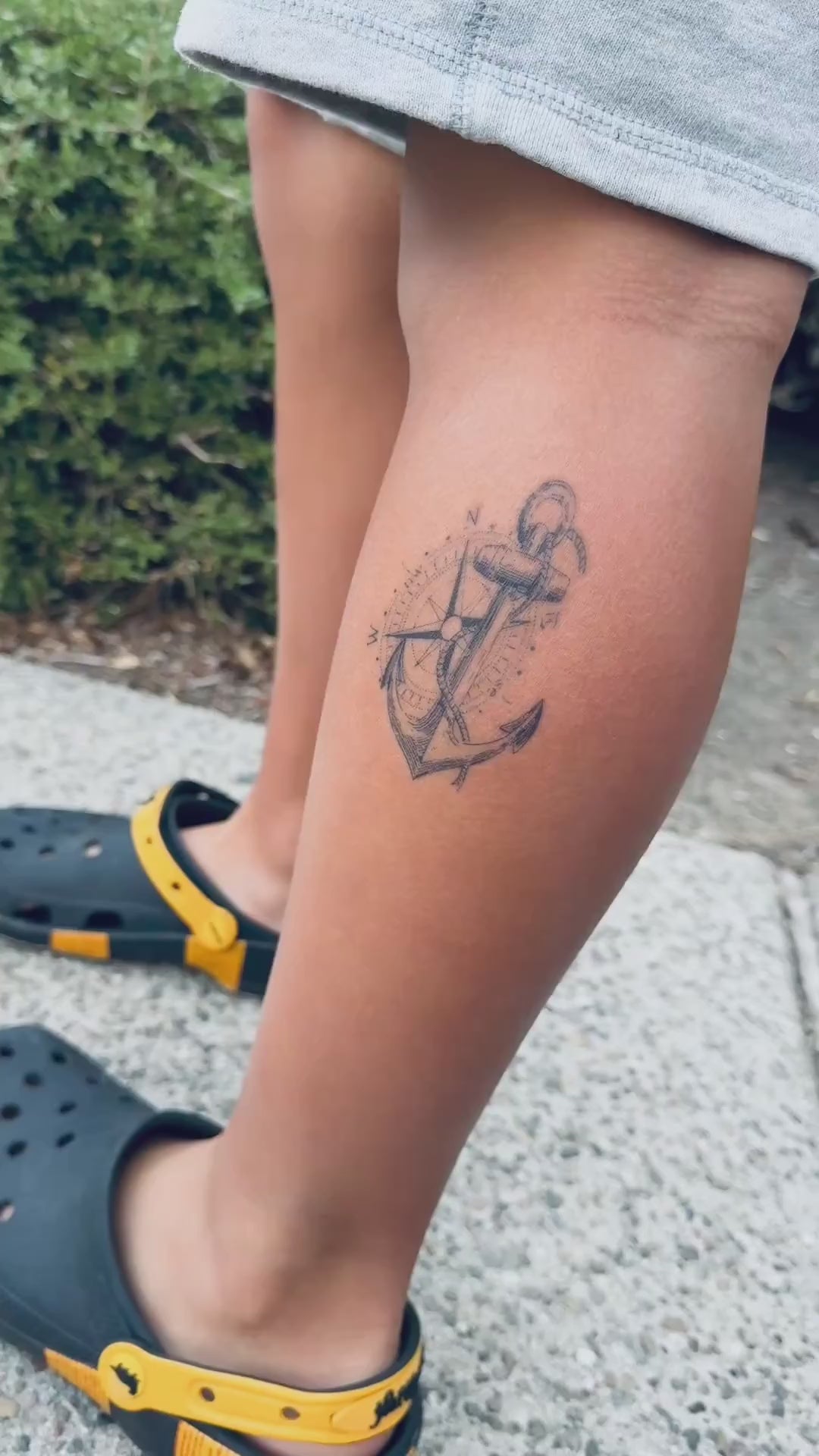 Close-up video of the True North Anchor water-free temporary tattoo on the lower leg, showing the realistic compass and anchor details on skin