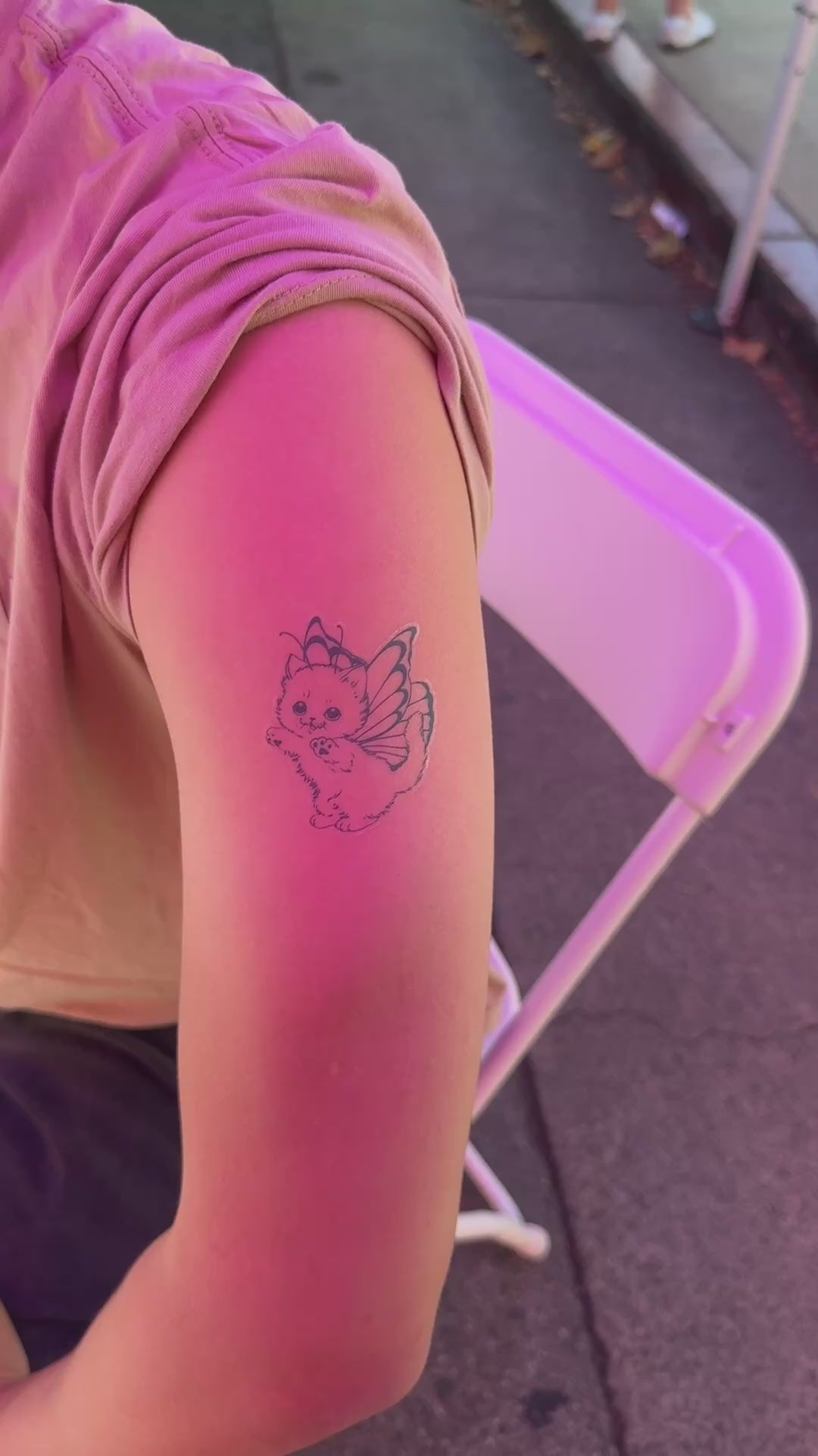 Customer showing the Butterfly Kitty fine line temporary tattoo on the arm
