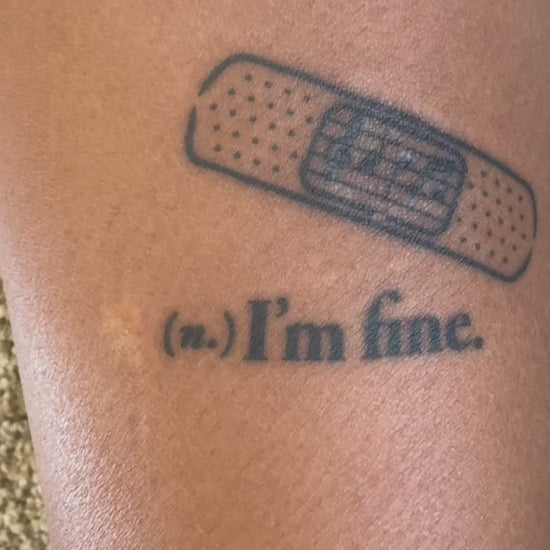 Before and after showing the I'm Fine bandage temporary tattoo transforming a scar into wearable art