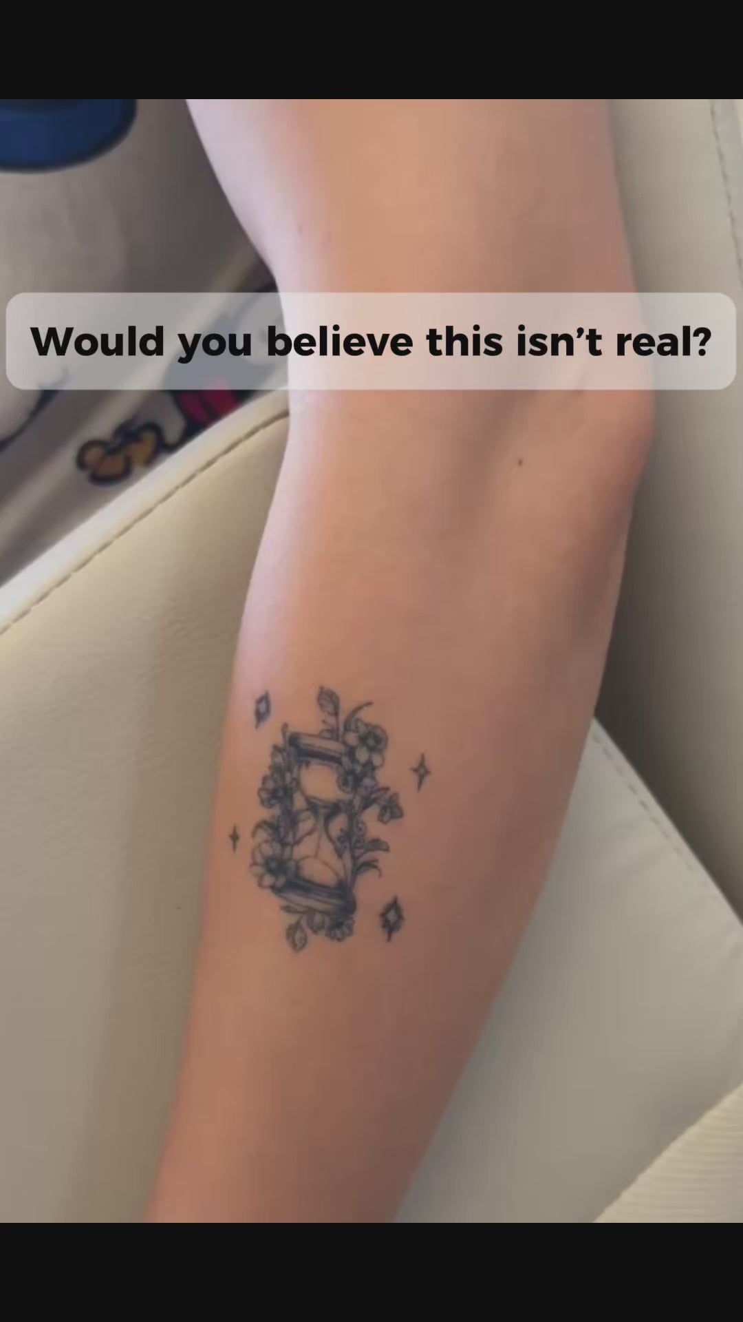 Close-up video of a woman wearing the Balance in Bloom floral hourglass water-free temporary tattoo on her forearm, highlighting its realistic fine line botanical design