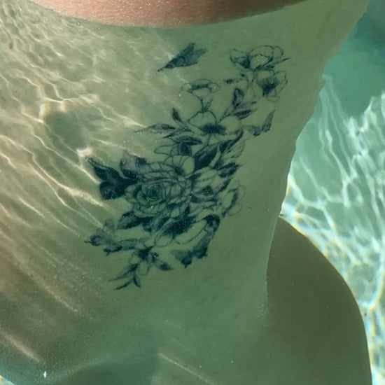 Secret Garden waterproof temporary tattoo underwater with a realistic fine-line floral design
