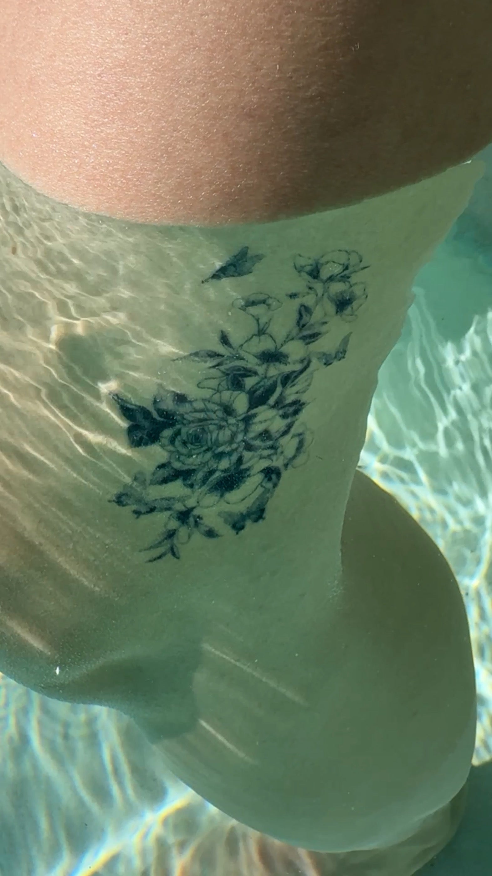 Secret Garden waterproof temporary tattoo underwater with a realistic fine-line floral design