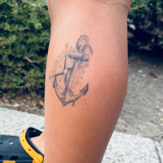 True North Anchor temporary tattoo with a detailed compass and anchor design on the lower leg